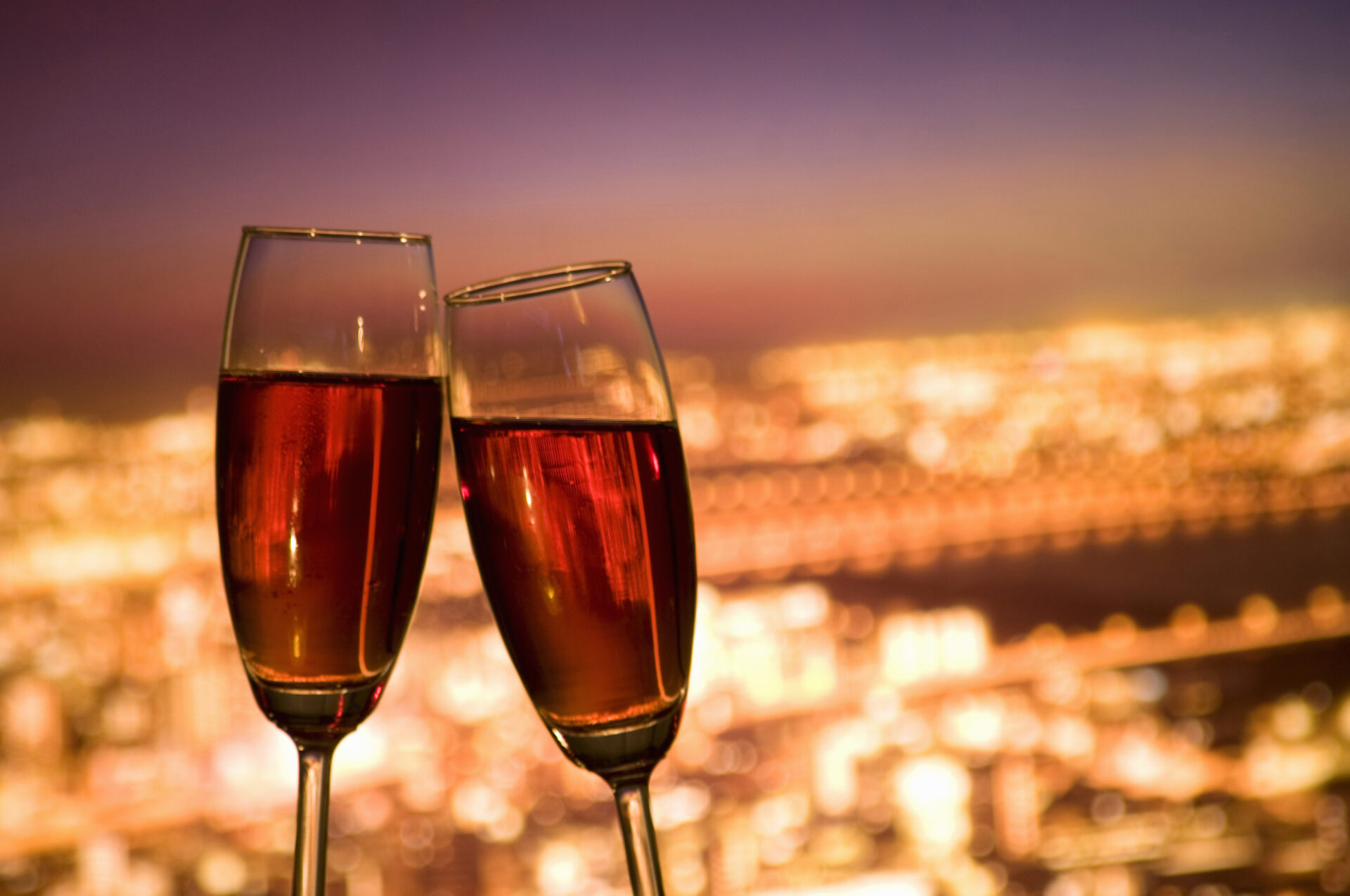 Champagne glasses clinking in a romantic toast during a couples getaway.